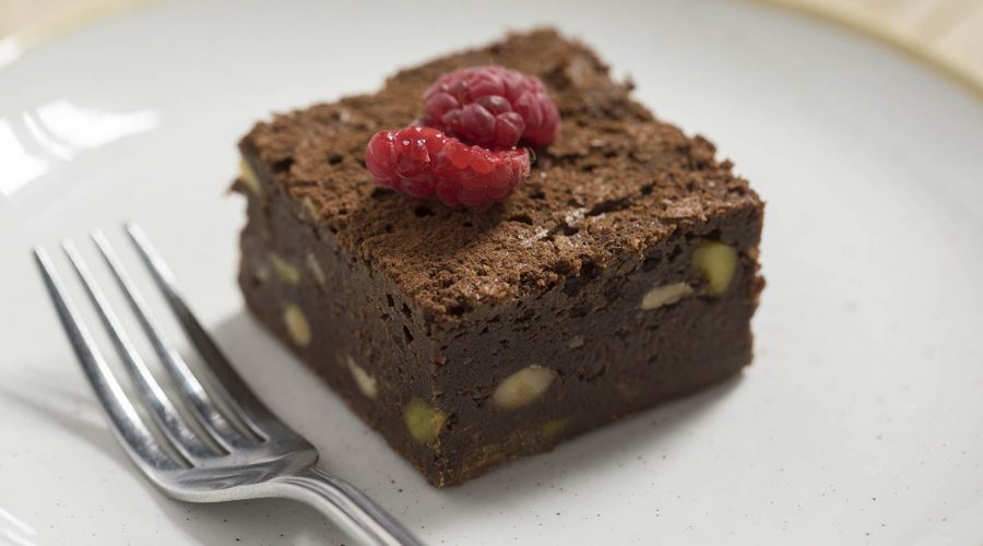 A square walnut brownie topped with 2 raspberries, made by the pastry chefs at Edinburgh cafe, Urban Angel.